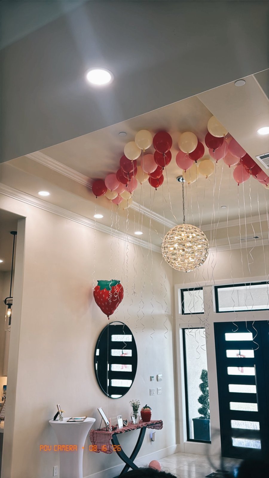 Red, pink and cream balloon ceiling with a strawberry balloon at the entrance