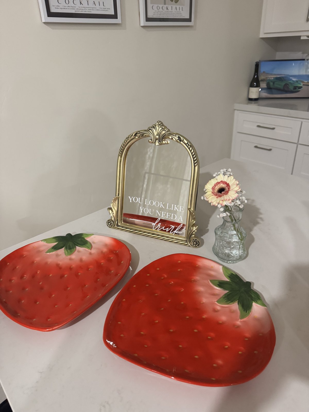 Strawberry platters and a mirror sign at the drink station