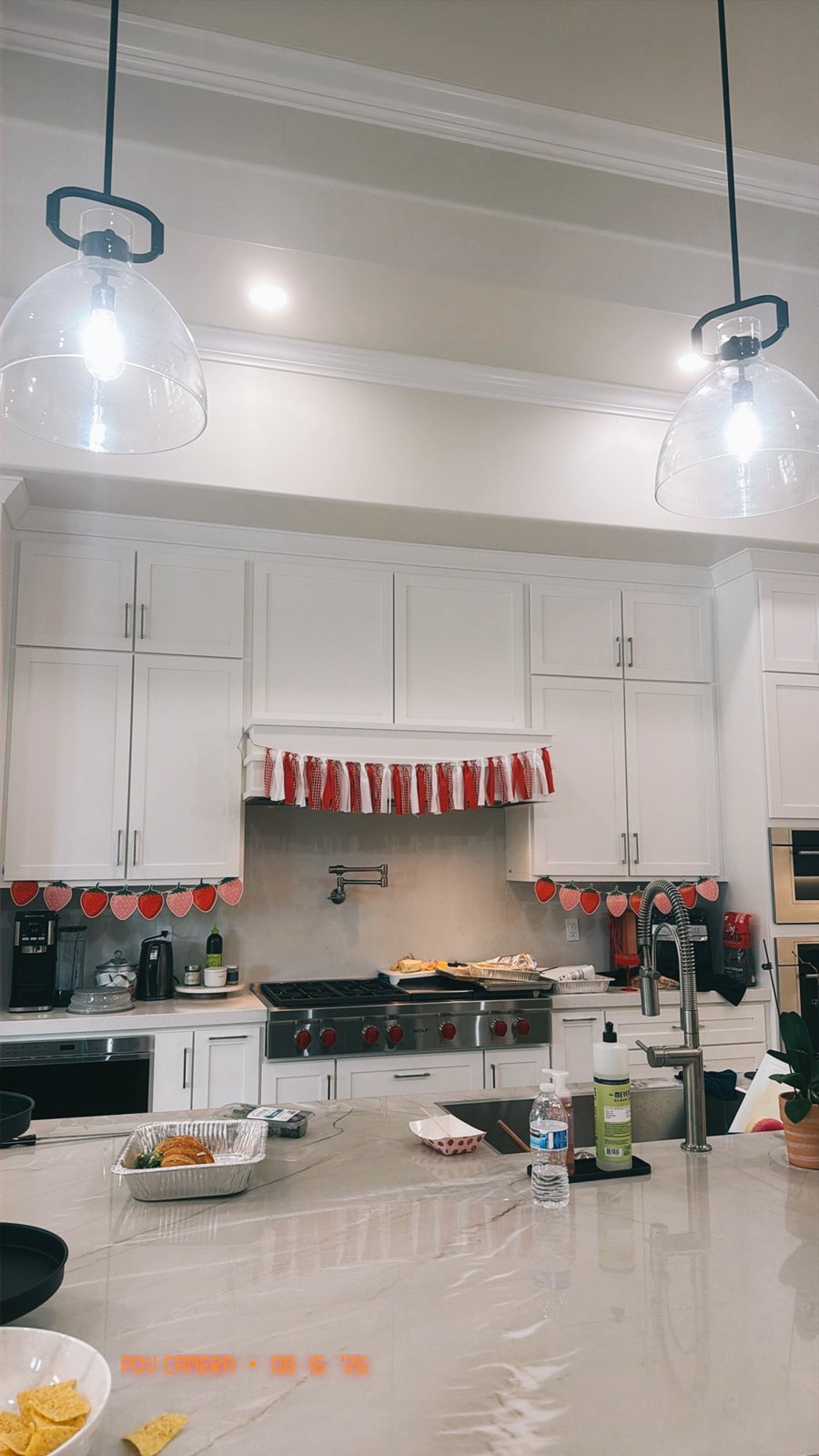 Kitchen dressed with a gingham tassel garland and strawberry bunting