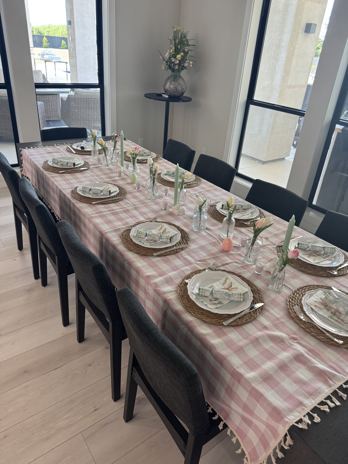 The Easter dinner table styled with pink gingham, woven placemats and spring florals