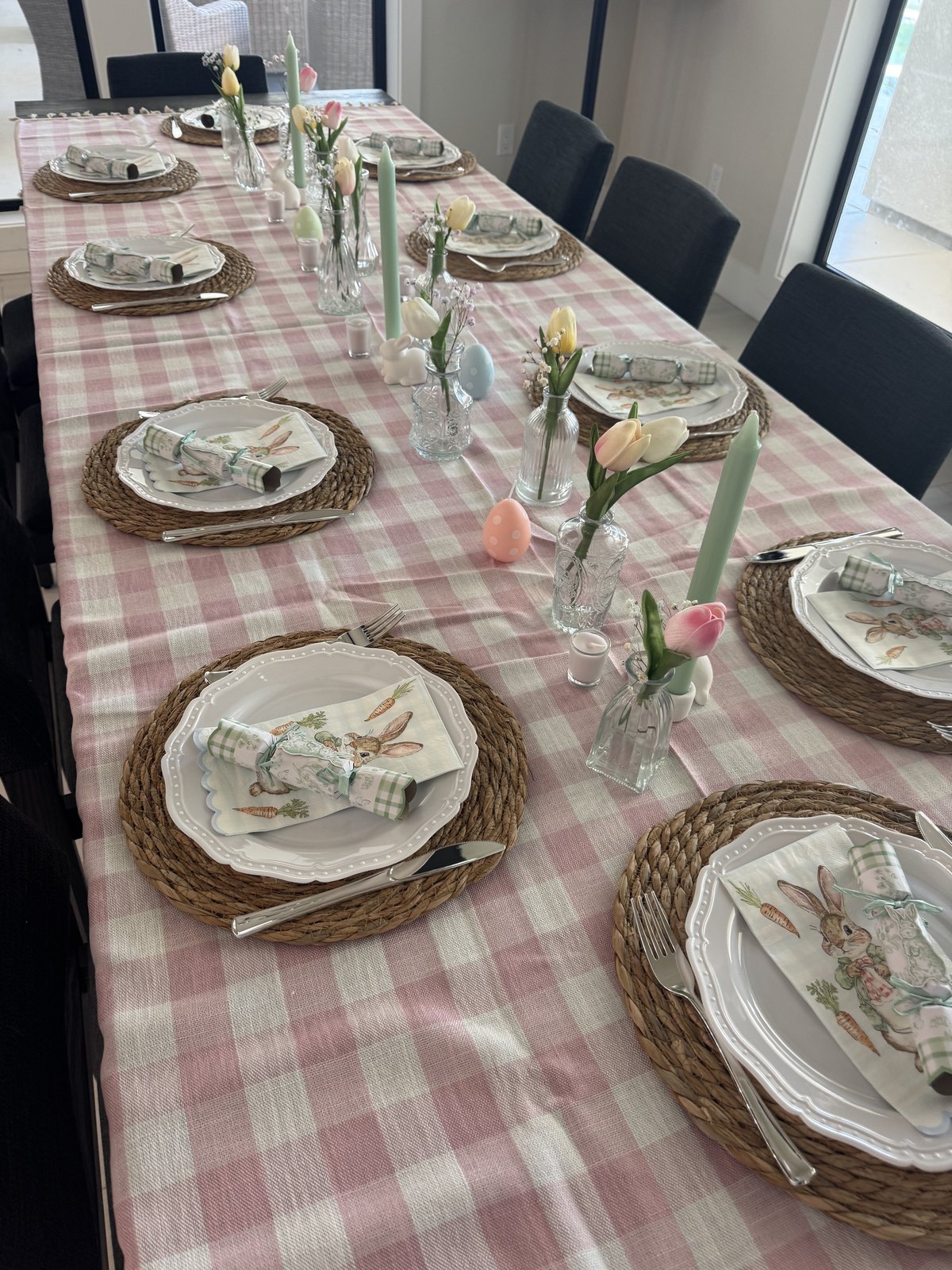 Easter table detail — bunny plates, pastel candles and tulip bud vases