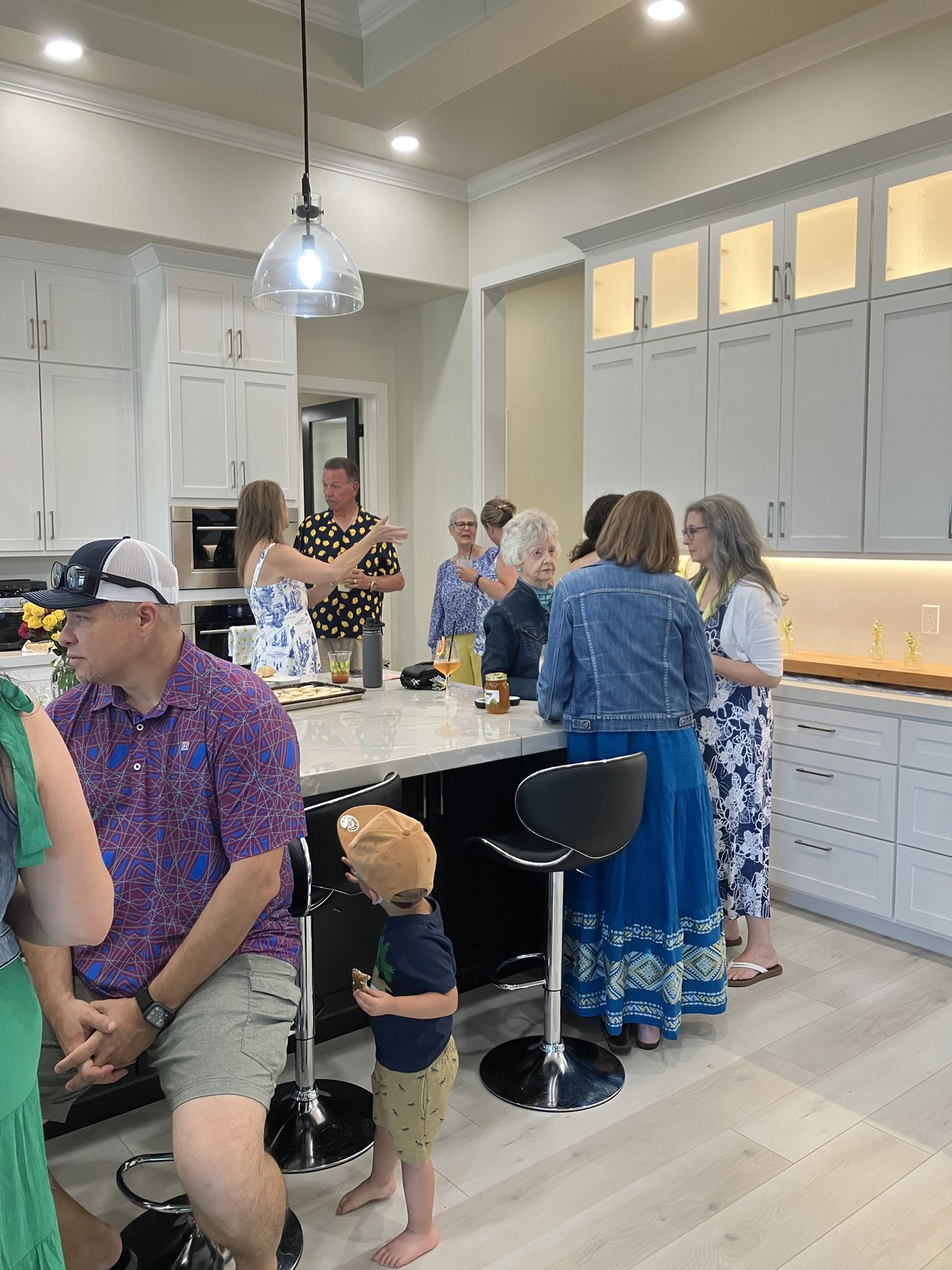 Guests gathered around the kitchen island during the graduation celebration