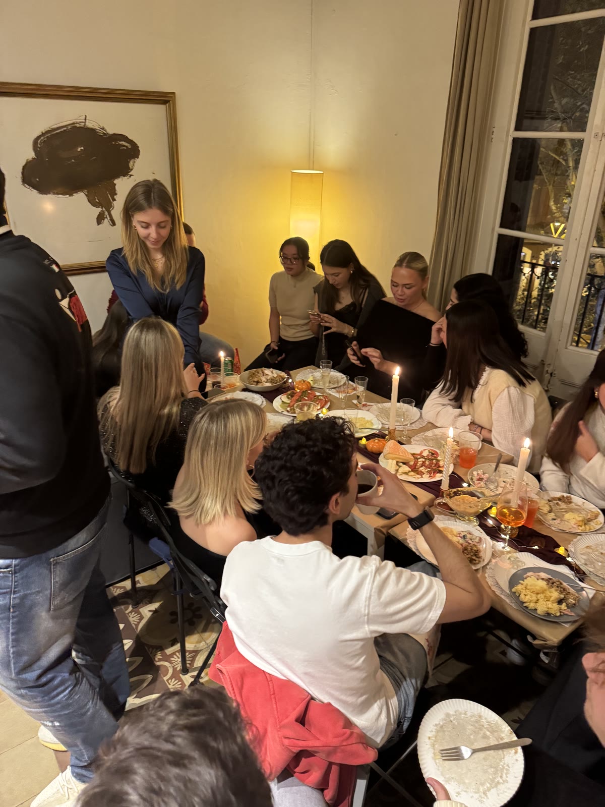 Friends gathered around the candlelit Thanksgiving table