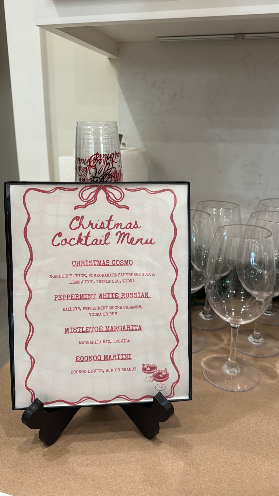 The hand-lettered Christmas cocktail menu on the drink bar