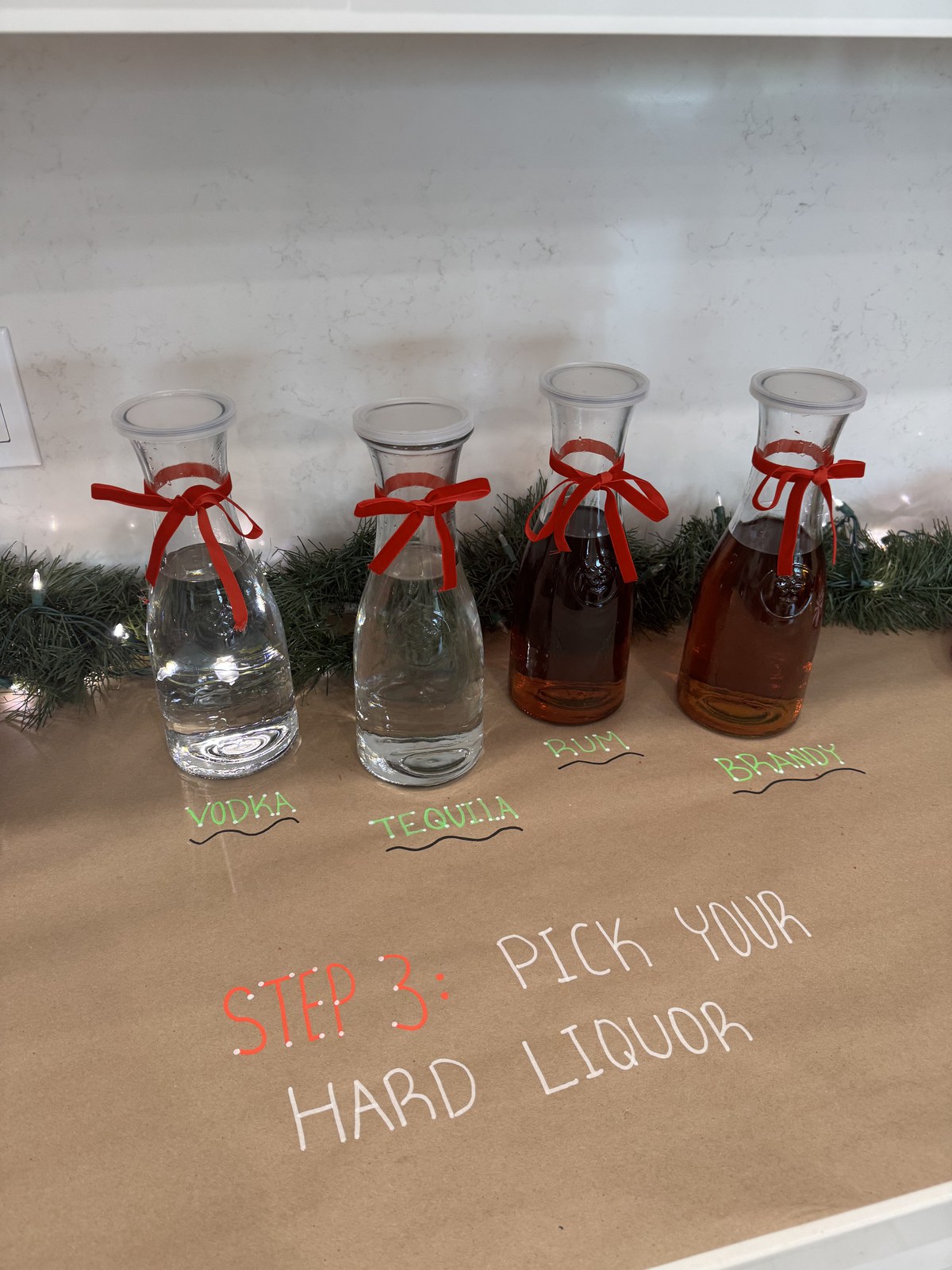 Step three — ribbon-tied carafes of vodka, tequila, rum and brandy